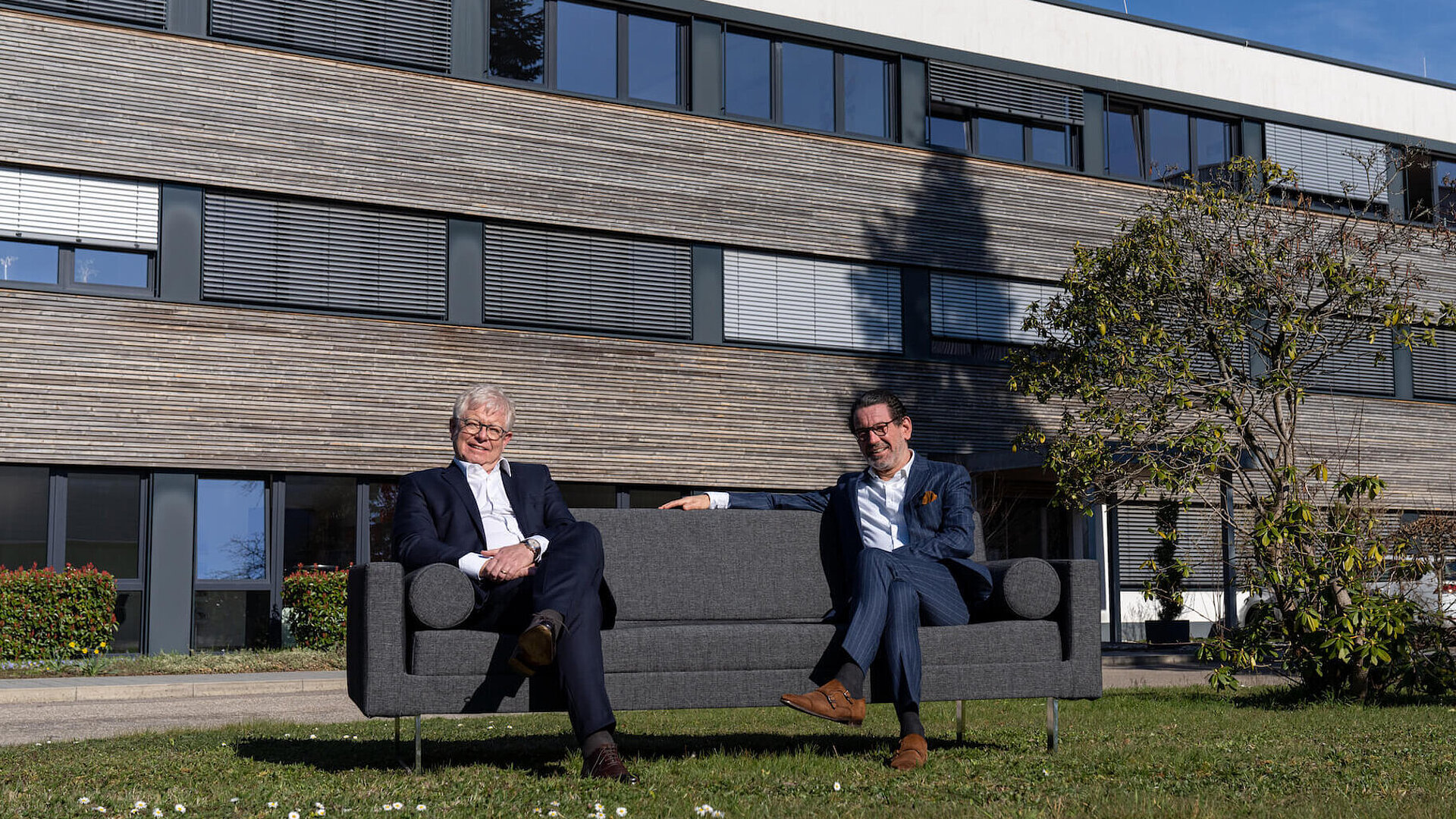 Management of Faller Packaging Faller Packaging management sitting in the green in front of the headquarters in Waldkirch