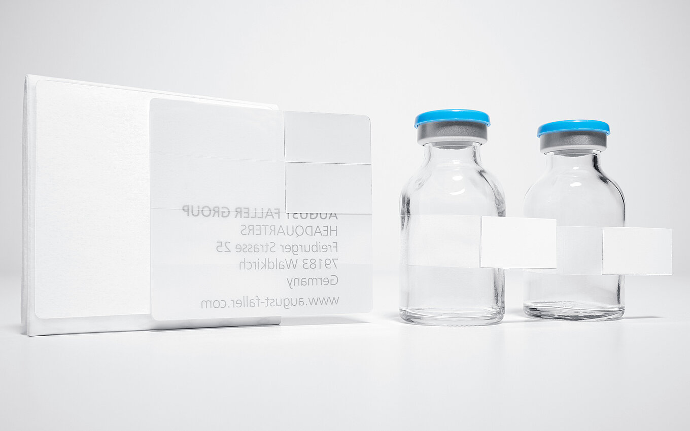 Glass vials with multi-page booklet label for pharmaceutical documentation by Faller Packaging.