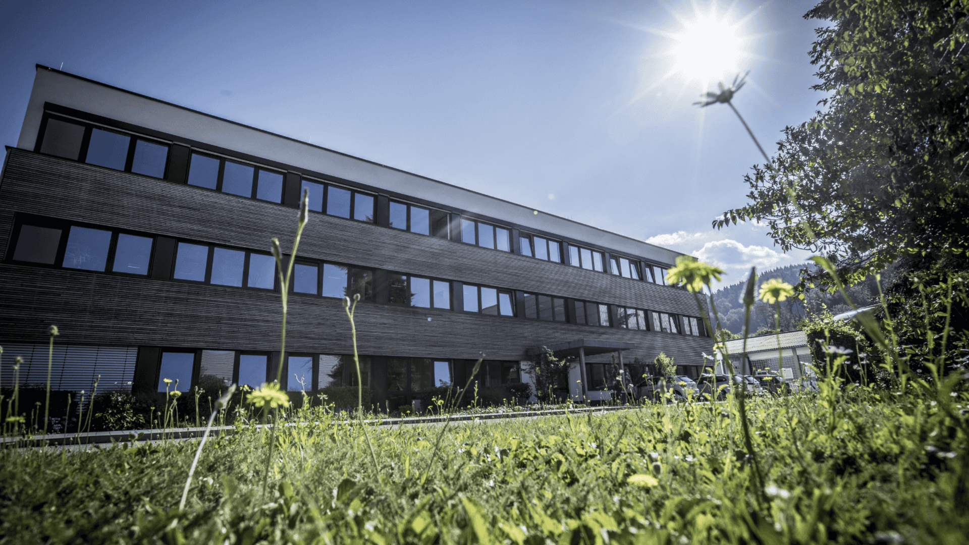 Headquarters of Faller Packaging in Waldkirch featuring modern industrial architecture and a green foreground